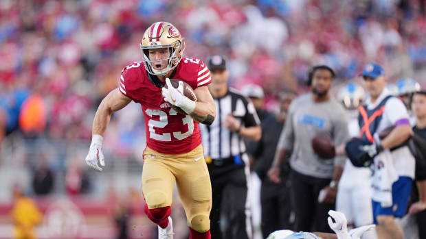Jan 28, 2024; Santa Clara, California, USA; San Francisco 49ers running back Christian McCaffrey (23) runs with the ball against Detroit Lions safety C.J. Gardner-Johnson (2) during the first half of the NFC Championship football game at Levi's Stadium. Mandatory Credit: Kyle Terada-USA TODAY Sports